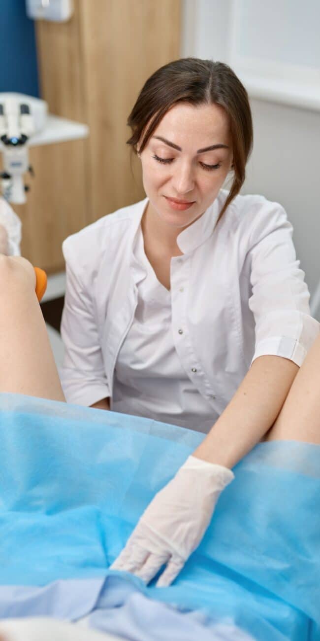 Doctor conducting gynecological routine examination of young woman